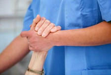 health care worker holding arm of patient