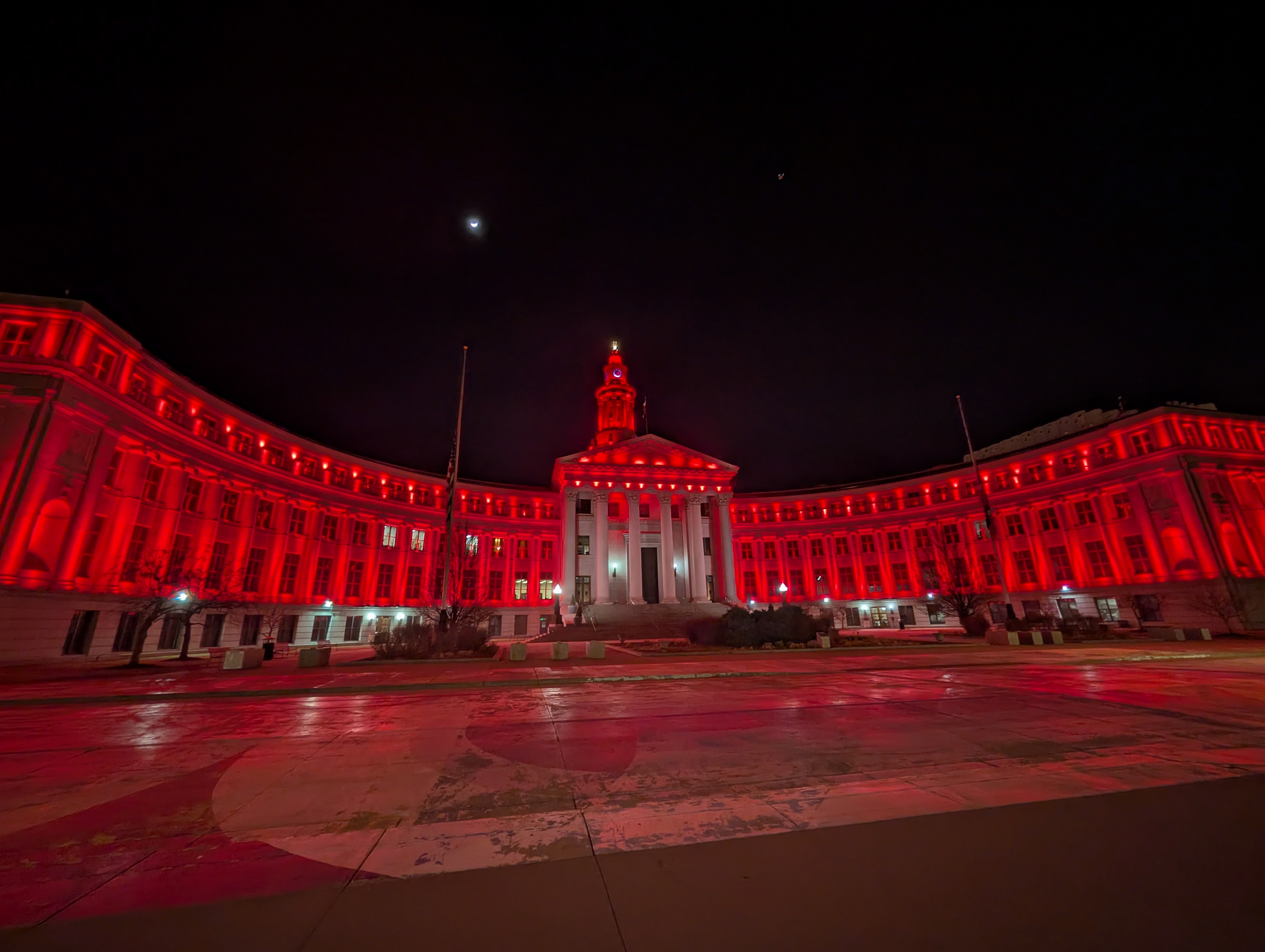 Denver city building lit up in red for World Encephalitis Day