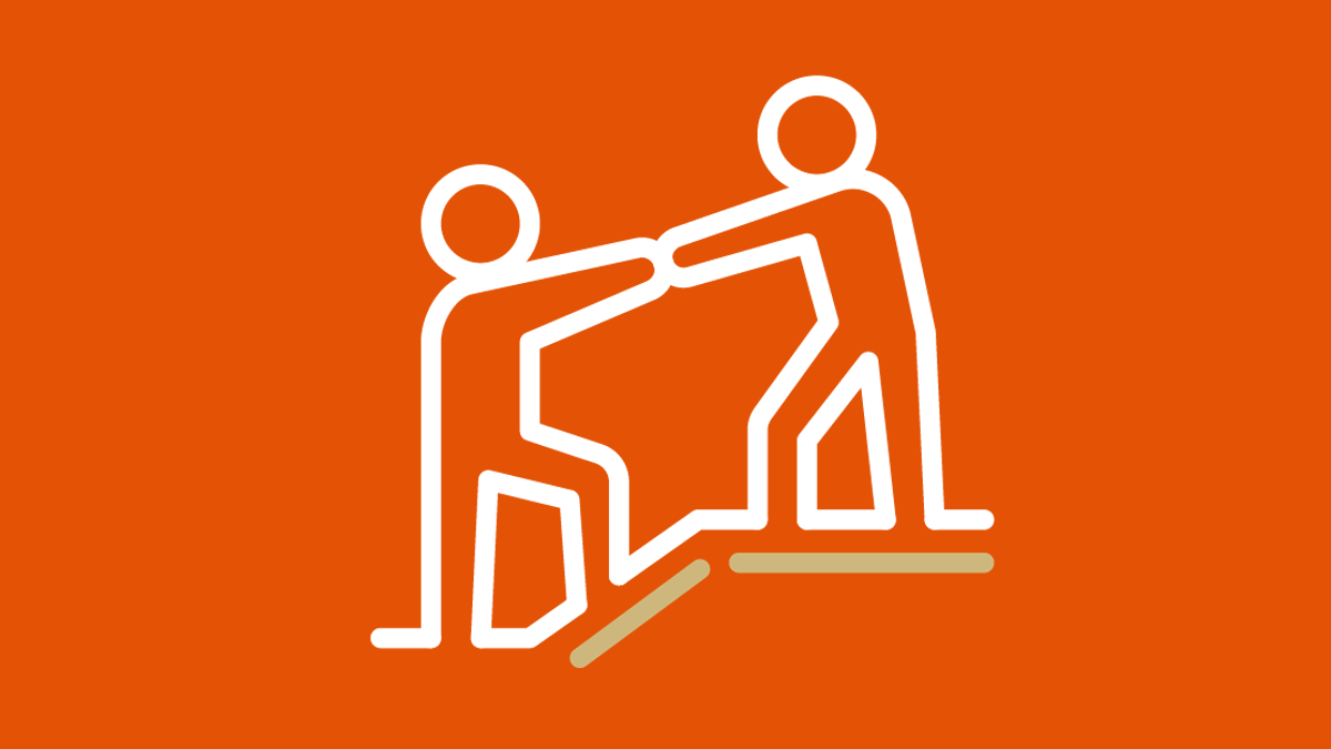 Person helping person icon on Brick by Brick orange background