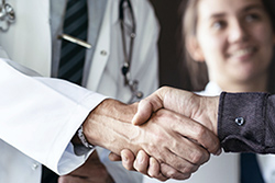 doctor shaking hands with patient