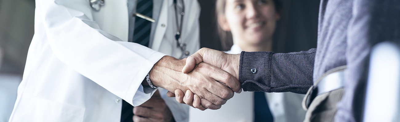 psychiatrist and primary care provider shaking hands
