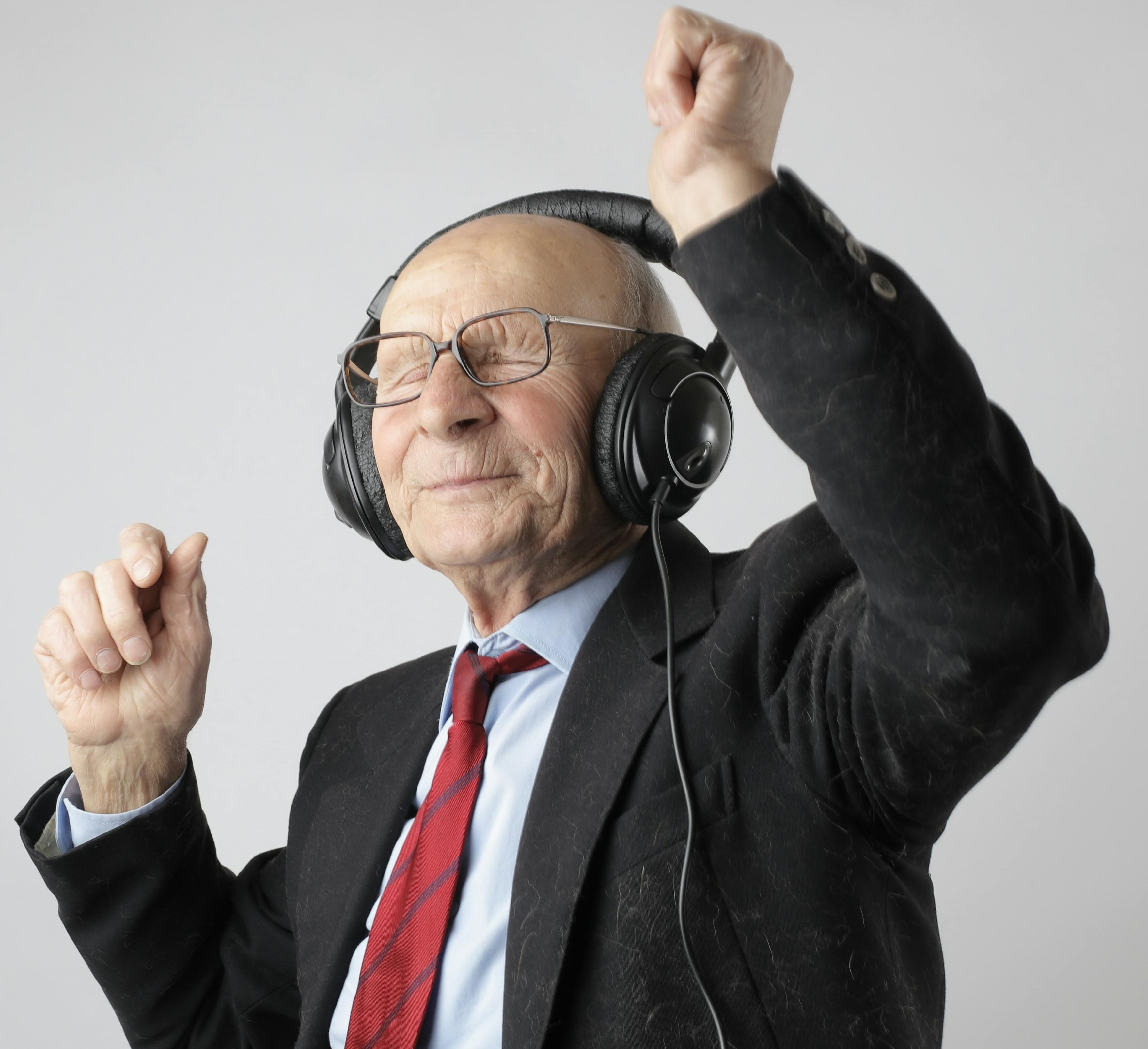 Older Adult in Suit with Headphones On