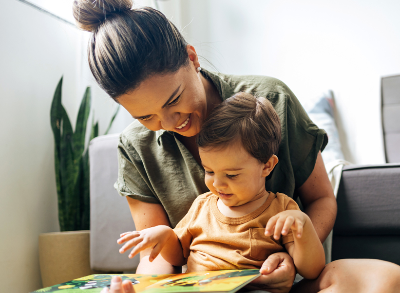 Woman reading a book with baby