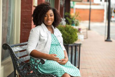 Pregnant woman sitting on a bench