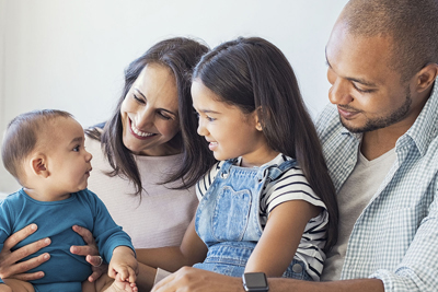 Family looking at infant
