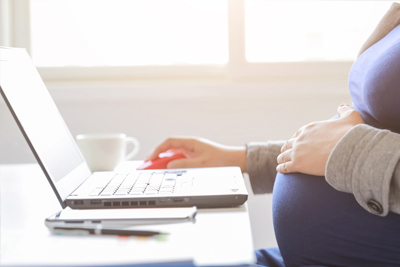 Pregnant woman with laptop