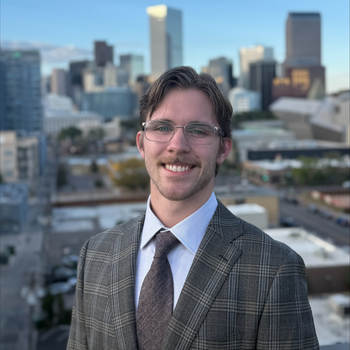 Man in glasses and a plaid suit