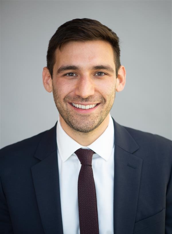 Professional headshot of man in suit