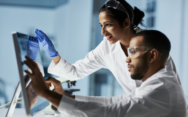 Two people at a computer screen in a lab