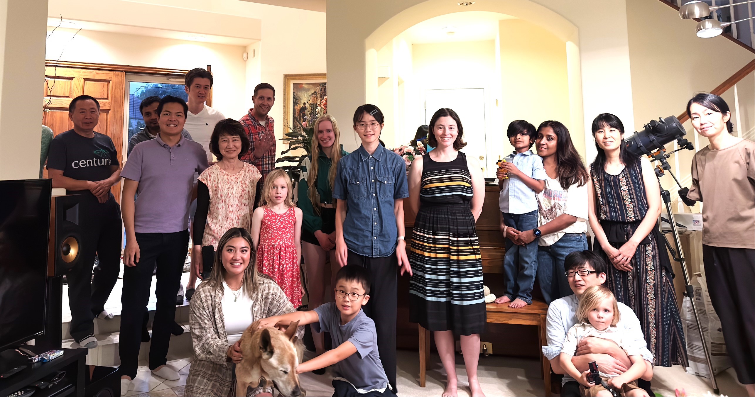 Members of the Fujita Lab 2024 standing in Dr. Fujita's living room, smiling