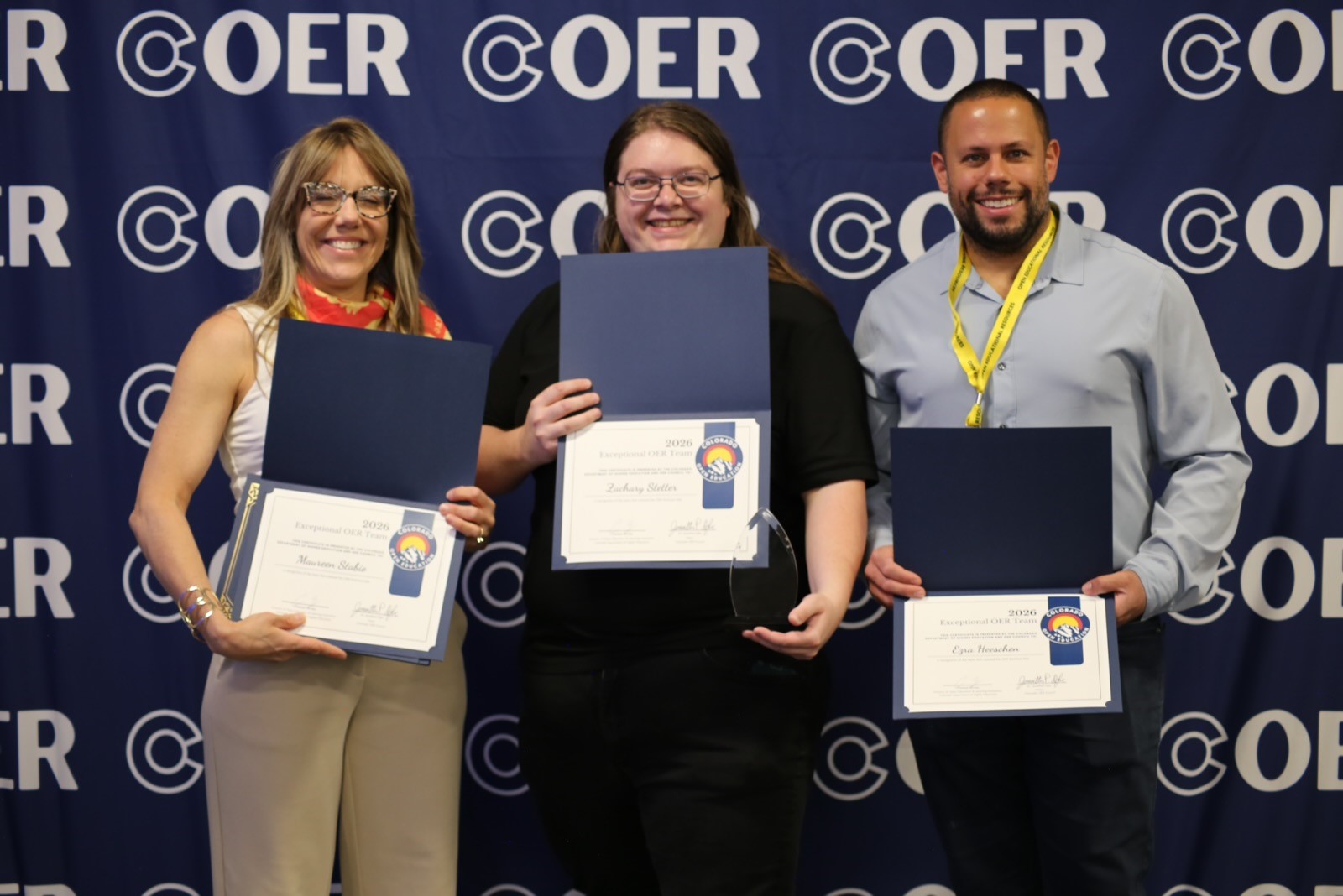 Dr. Stabio, Zach Stetter, and Ezra Heeschen hold up award certificates