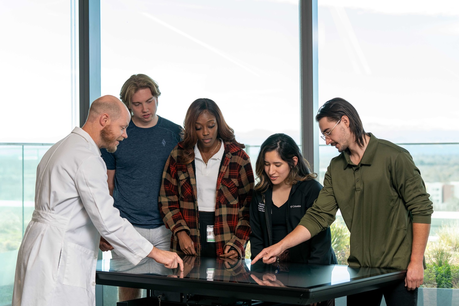 Students interacting with a Sectra Table