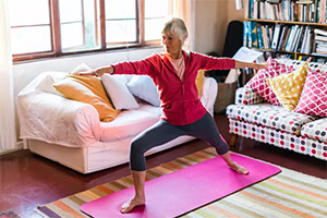 woman in living room doing yoga