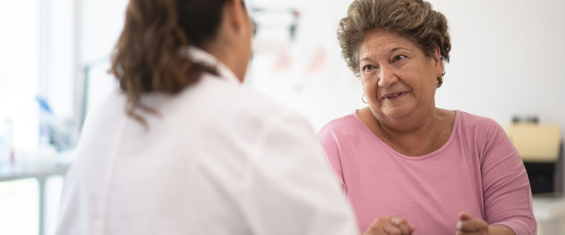 Image of an older adult speaking with a researcher.