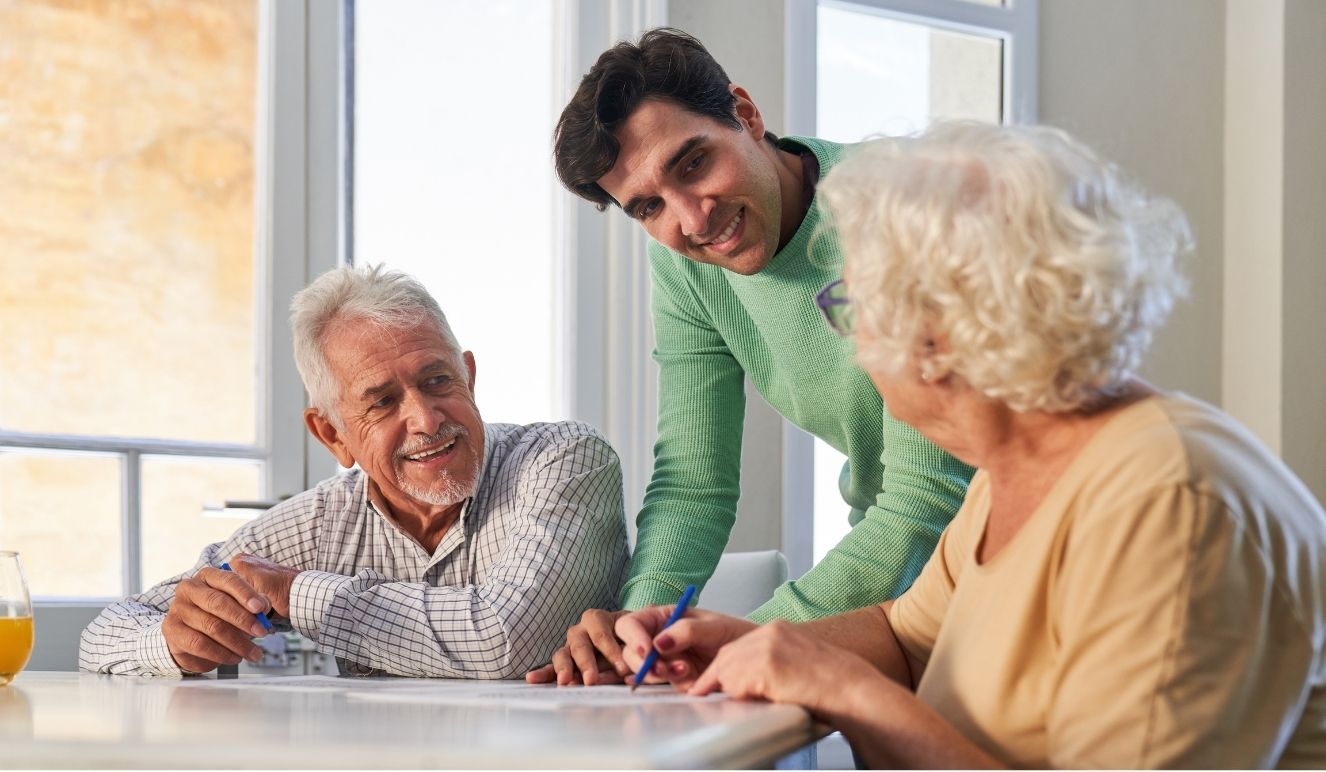 A family caregiver speaking with older adults.