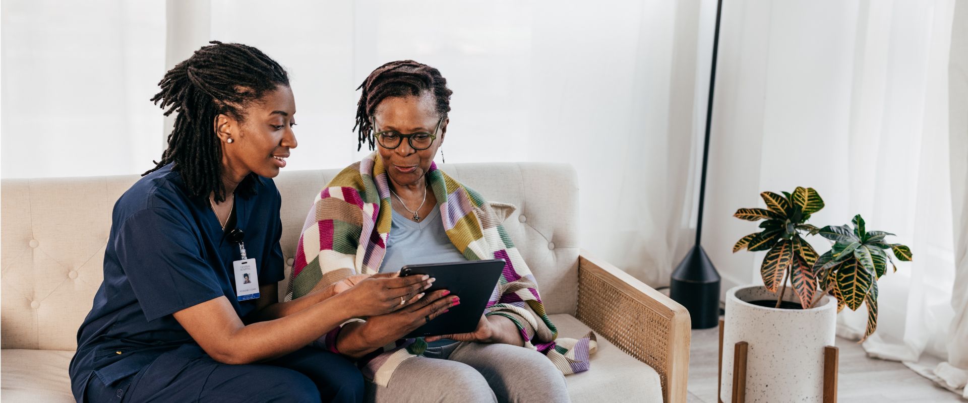 Nurse and older adult discussing research.