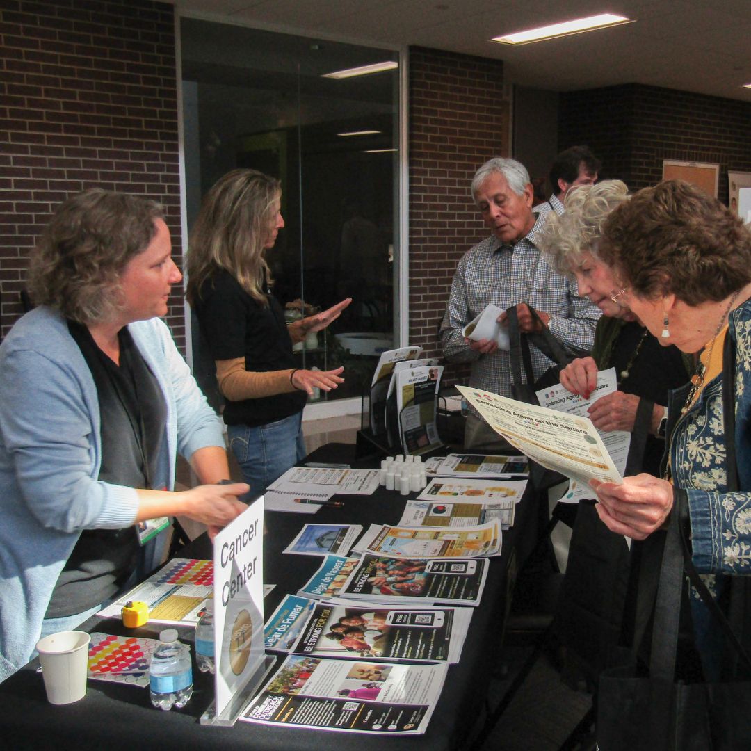 Community members interact with researchers at a Research Roadshow.