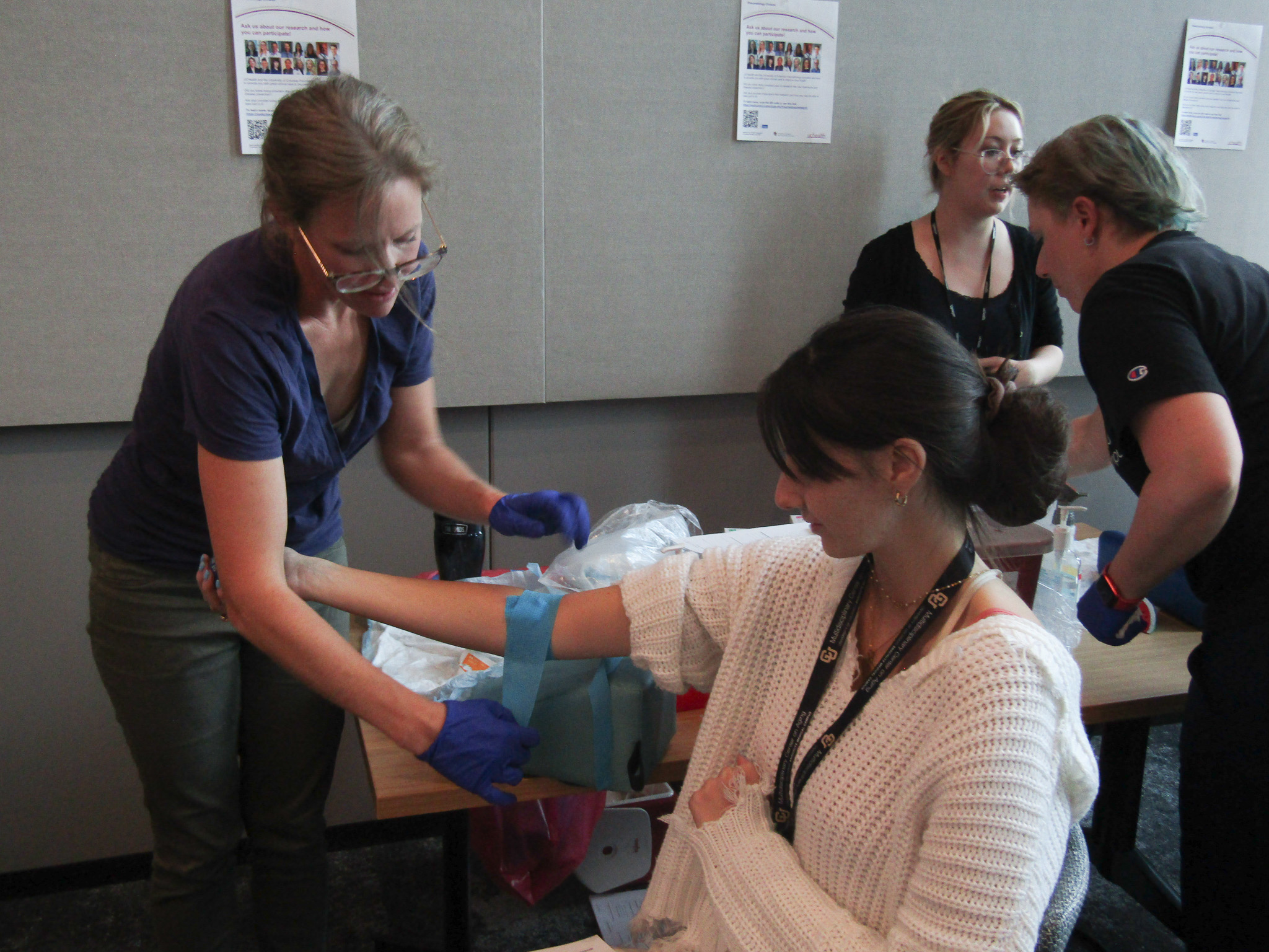 A participant gets her blood drawn during the Research Roadshow.