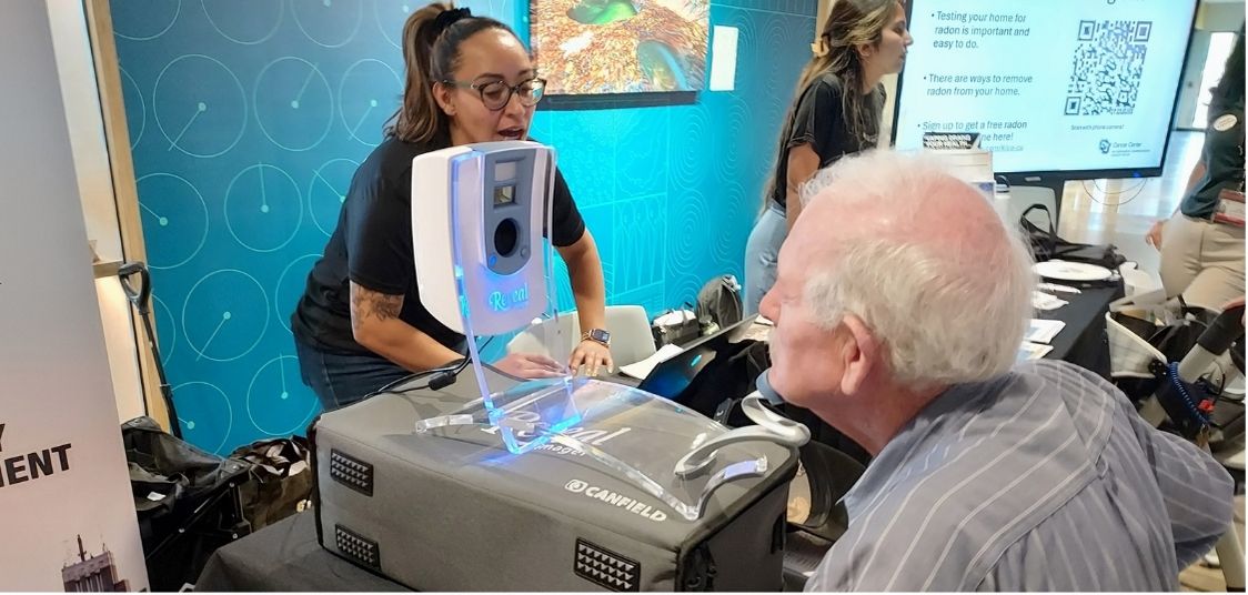 Attendee trying out a cancer screening at the event.