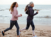 two women running on a beach