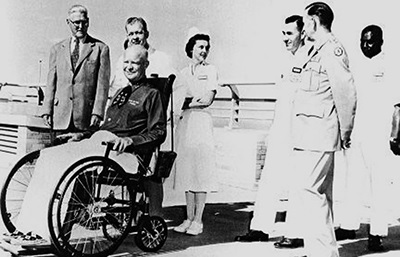 PresidentEisenhourinwheelchairatBuilding500