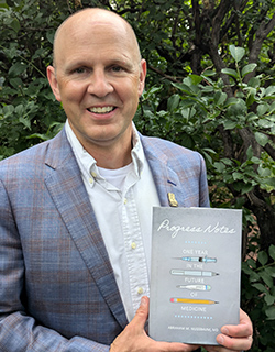 Abraham Nussbaum, MD holding book