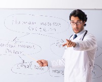 Person in white coat using white board to teach