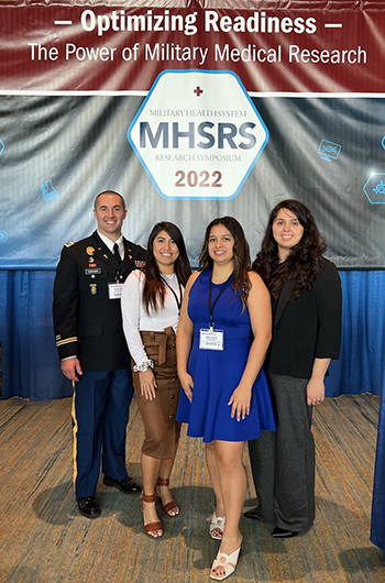 Lt. Col. Steven Schauer, DO, MS, with his research team at the Military Health System Research Symposium in 2022.