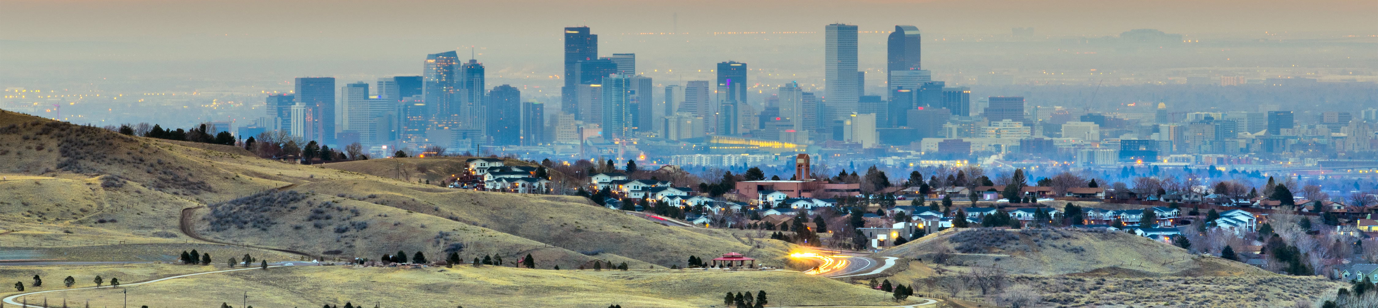 denverskylinewithbluebuildingsandrollinghills