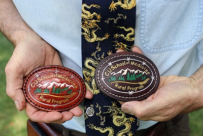 arkDeutchmanMDshowsoffcustommadeRuralProgrambeltbuckleswhichhemakeswithstudentseachyear
