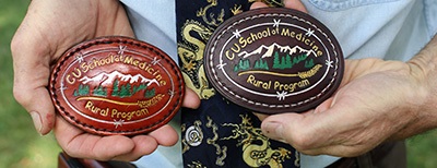 arkDeutchmanMDshowsoffcustommadeRuralProgrambeltbuckleswhichhemakeswithstudentseachyear