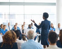Woman presenting to a group of physicians