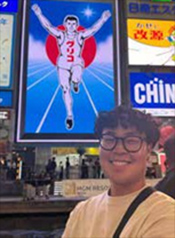 Joseph Lim in front of poster