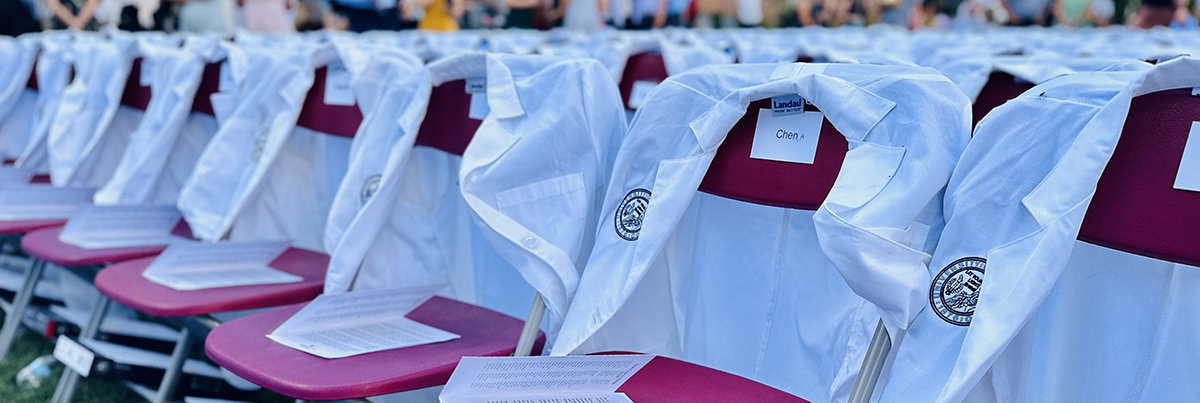 White coats draped over the backs of chairs in Boettcher commons.