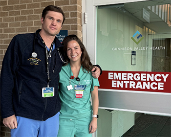 CU medical student Michael Nocek and Kelly Stewart, MD, a rural track alumna, standing outside emergency entrance att Gunnison Valley Health.