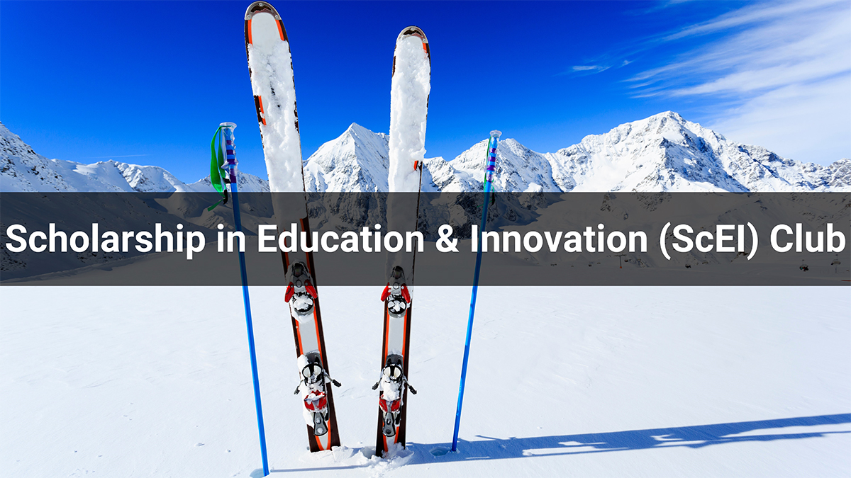 ski poles and skis artfully set in snow with mountain backdrop