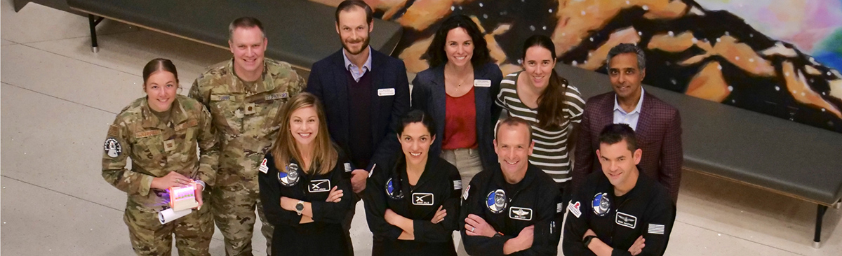 Group shot of polaris. Prem Subramanian, MD, PhD, (back row, far right) and Allie Hayman, PhD, (back row, third from right) with the Polaris Dawn crew.