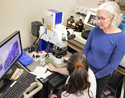 Stephanie Bryant in her lab with a coworker among computers