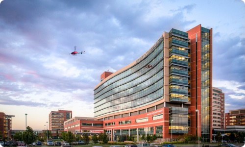 UCHealthbuildingwithcloudsandhelicopter