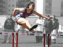 Woman jumping hurdles