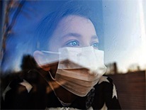 childinamasklookingoutawindow