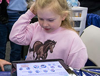 Young girl looking at a computer