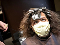 woman getting hair color at salon