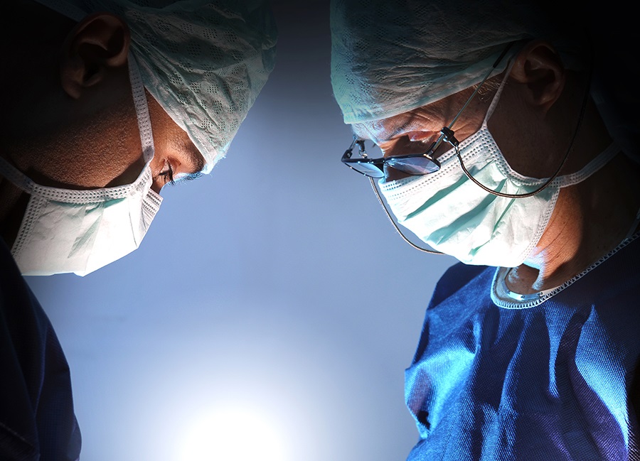 twodoctorslookingdownwearingmasks