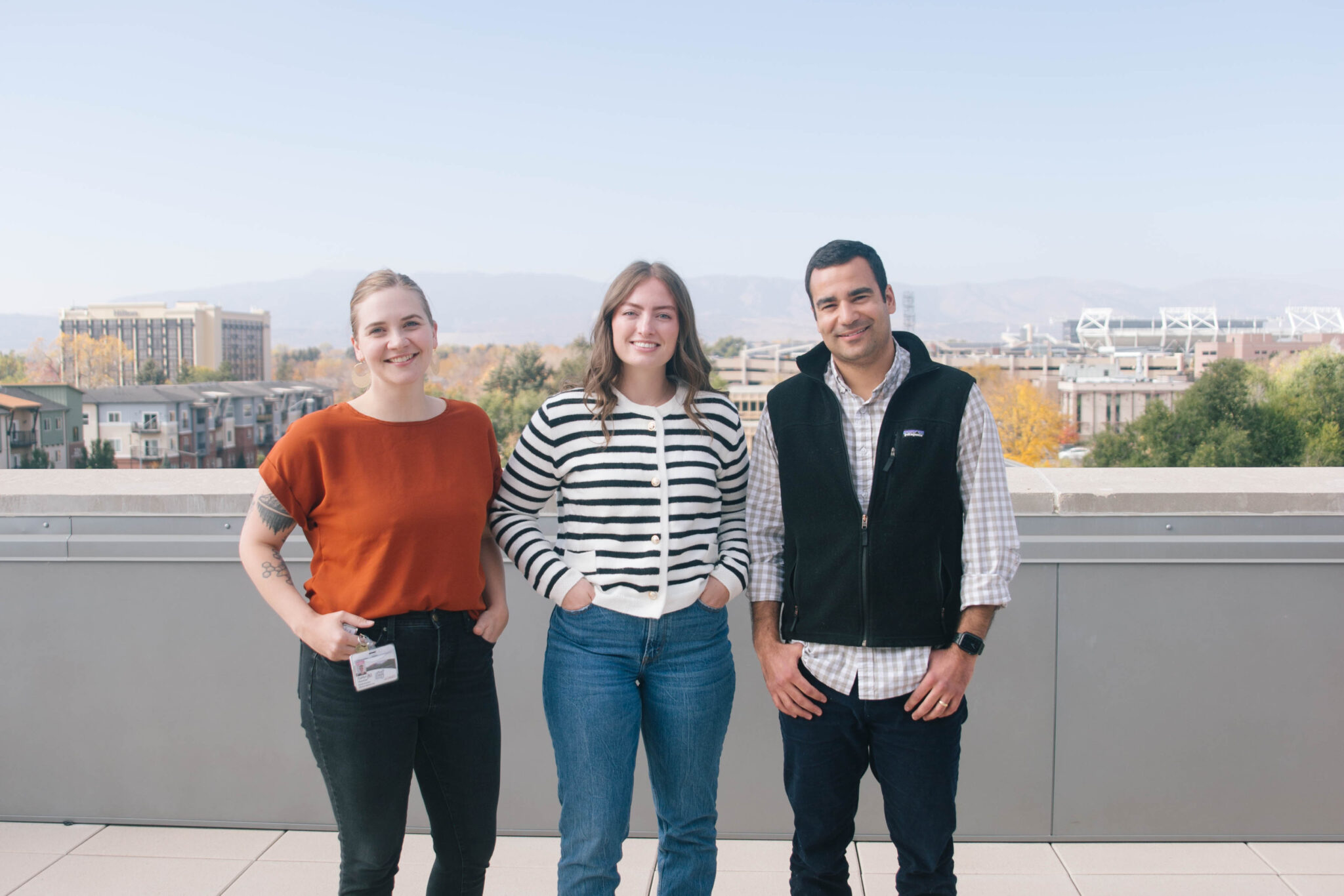 From left, third-year CU SOM at CSU medical students from the inaugural class of 2025 KC Hummer, Megan Mazzotta and Raj Trikha on the balcony of the CSU Health Network and Medical Center. Photo by Kellen Bakovich