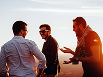 threemenoutsidelaughingandwalking