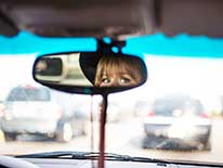 Woman's eyes in rear view mirror