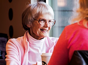 womanattablewithcoffeetalkingwithanotherwoman