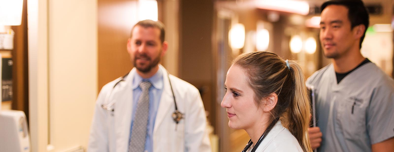 threestudentsonclinicalrotationinhallwayatuch