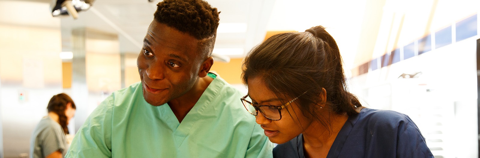 Twostudentsinscrubsinanatomylab